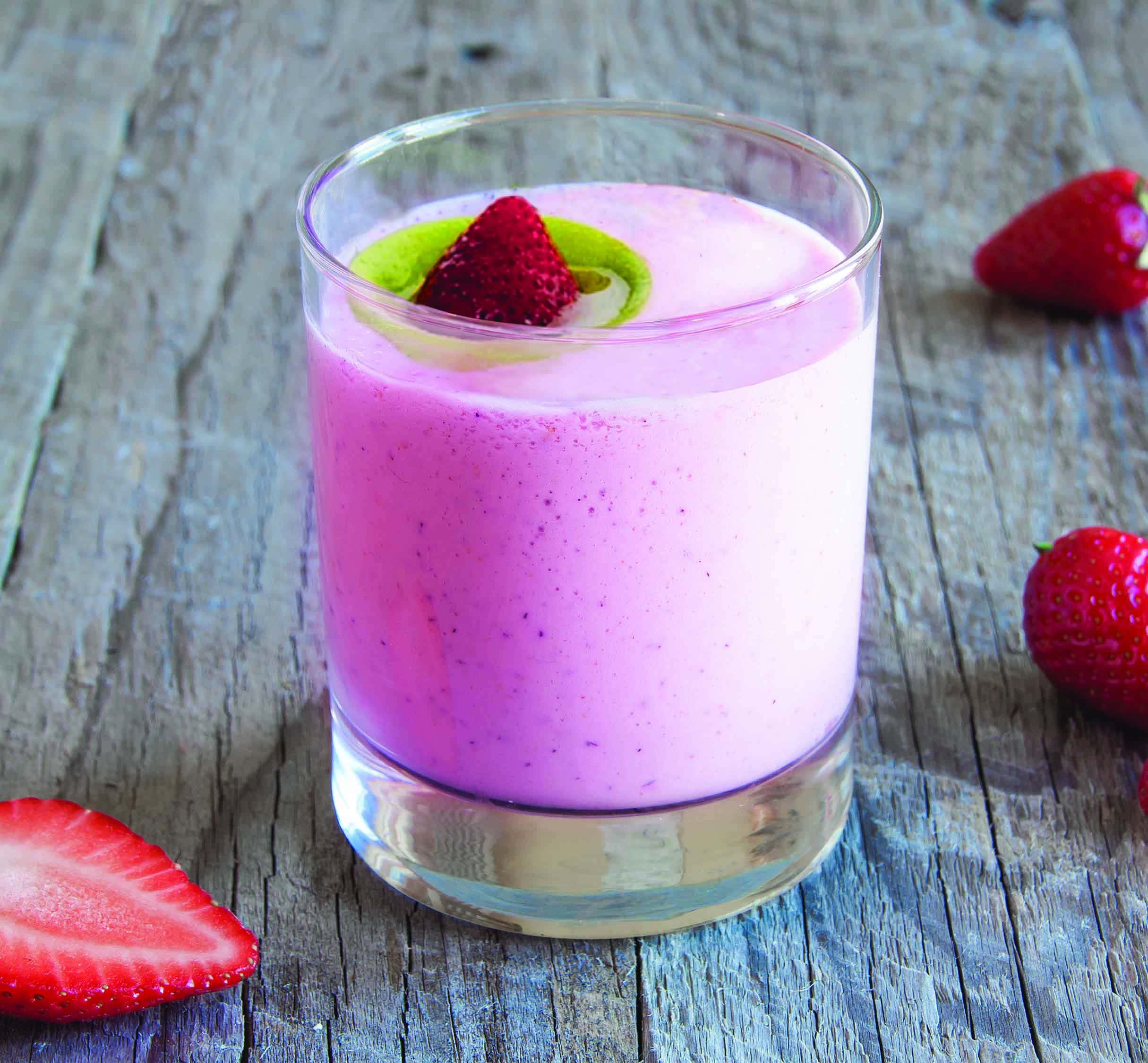 pink drink in rocks glass with strawberry garnish