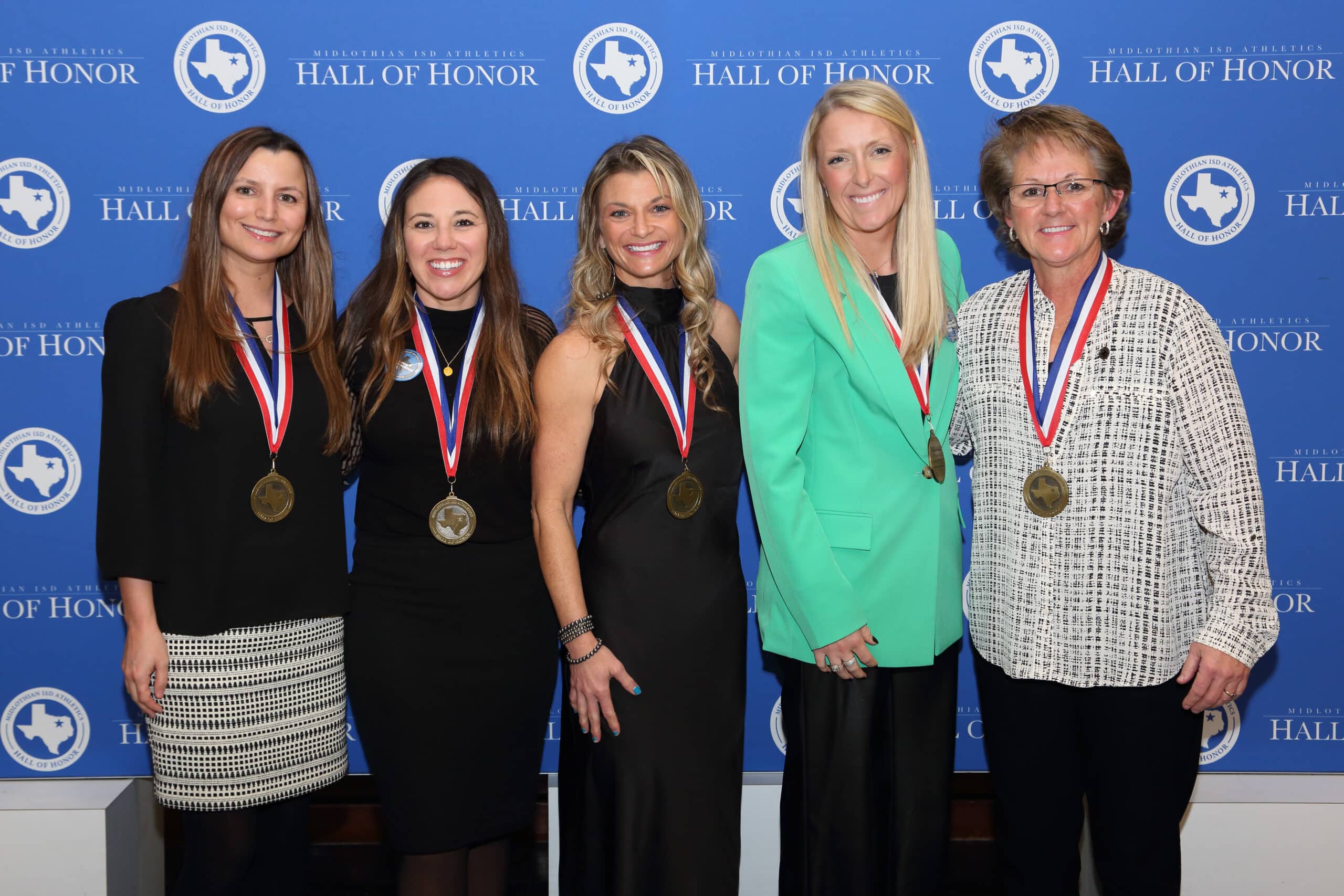 five ladies wearing medals on their necks