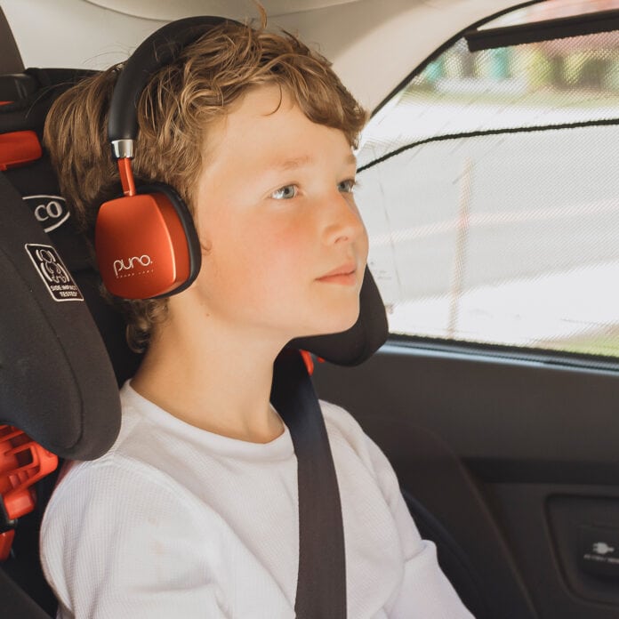 kid wearing red over the ear headphones