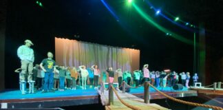 First musical in Midlothian Heritage High School auditorium a big deal, er fish large group of people on a stage