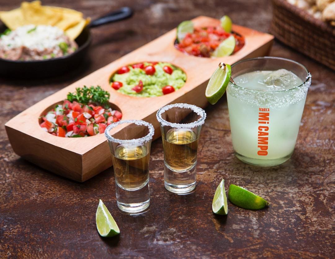 salsa tray shots of tequila and a margarita