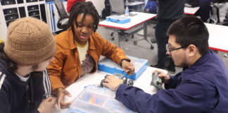 Cedar Hill STEM Seniors Thrive in Fledgling Robotics Program three young men sitting at table