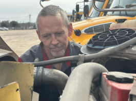 Mike Raidy working on vehicle