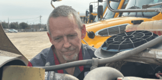 Mechanic With Four Decades of Experience Joins Cedar Hill ISD Mike Raidy working on vehicle