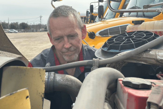 Mike Raidy working on vehicle