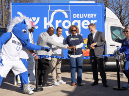 people with Dallas Maverick mascot cutting a ribbon