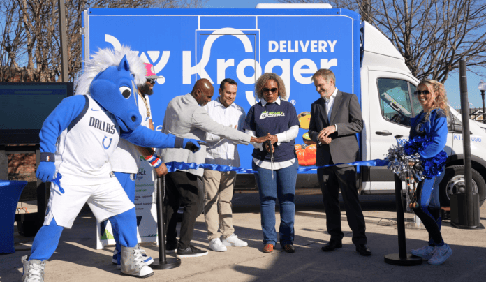 people with Dallas Maverick mascot cutting a ribbon