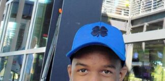 young black man wearing a baseball cap