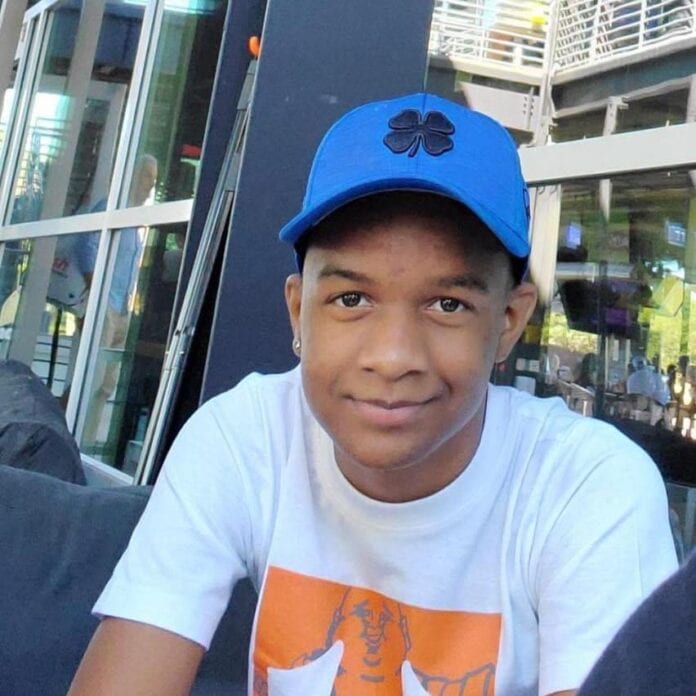 young black man wearing a baseball cap