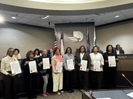 group of ladies holding proclamation