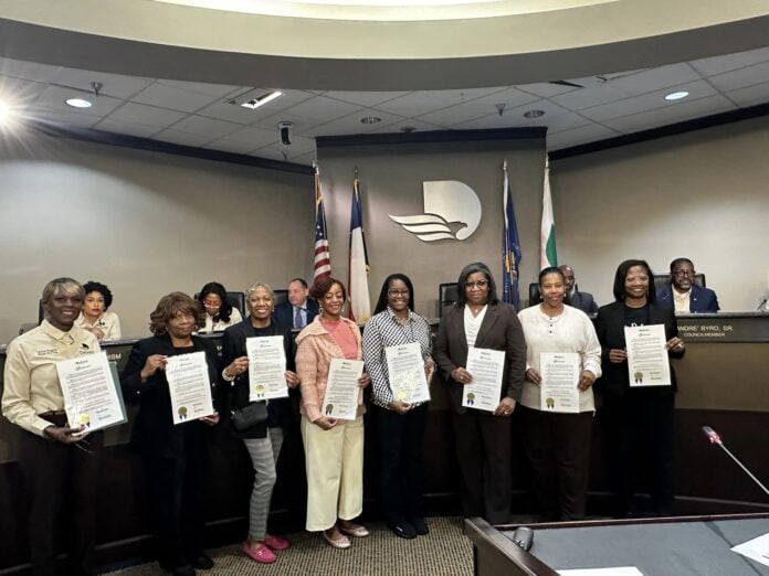 group of ladies holding proclamation