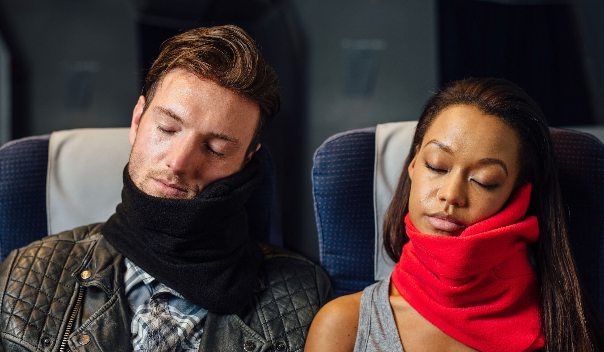 man and woman using travel pillow