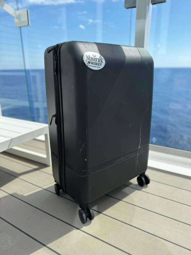 Nomatic suitcase wth ocean in background
