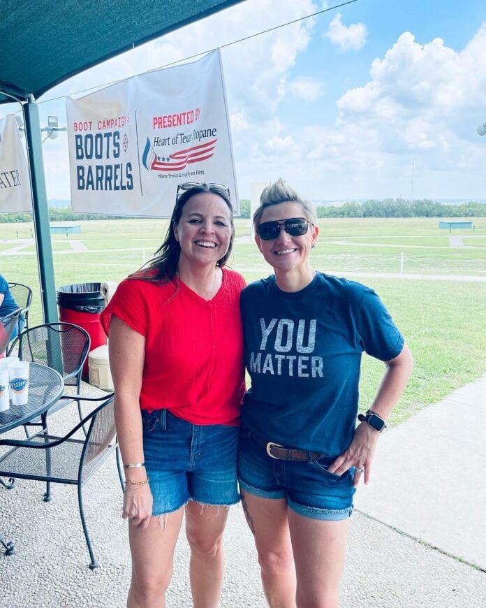 two ladies standing together outside