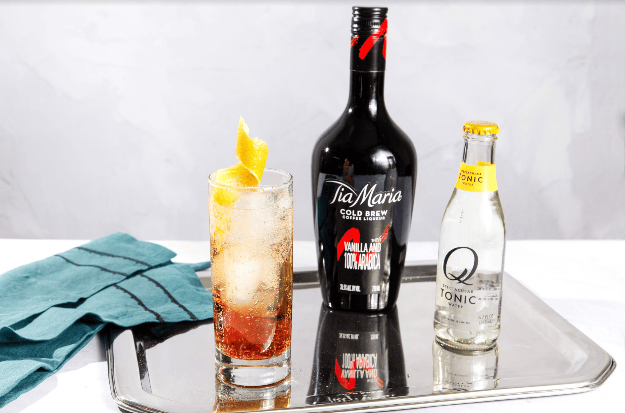 Tia Maria bottle with cocktail and tonic bottle