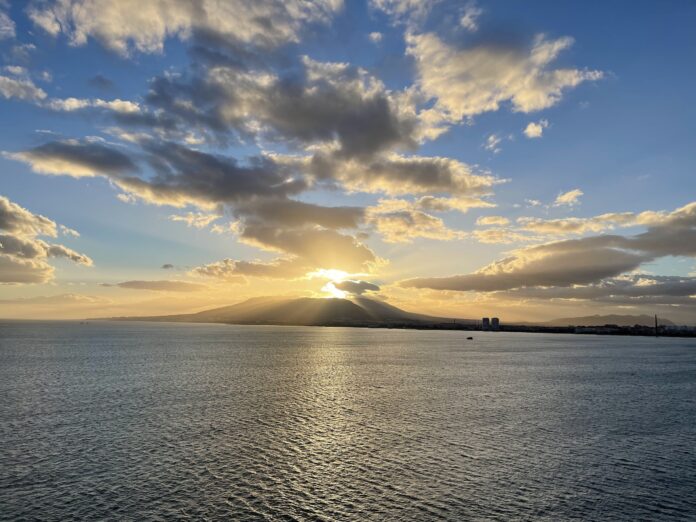 ocean with mountain and sunset