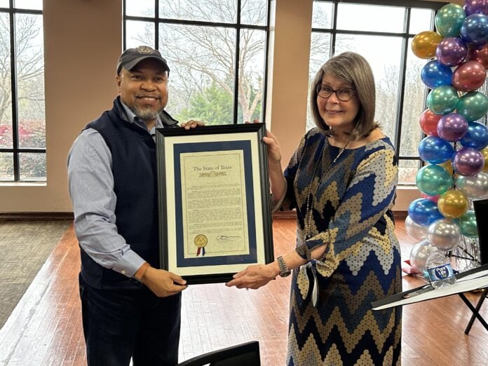 Kathy Jones with Carl Sherman Jr. holding a frame