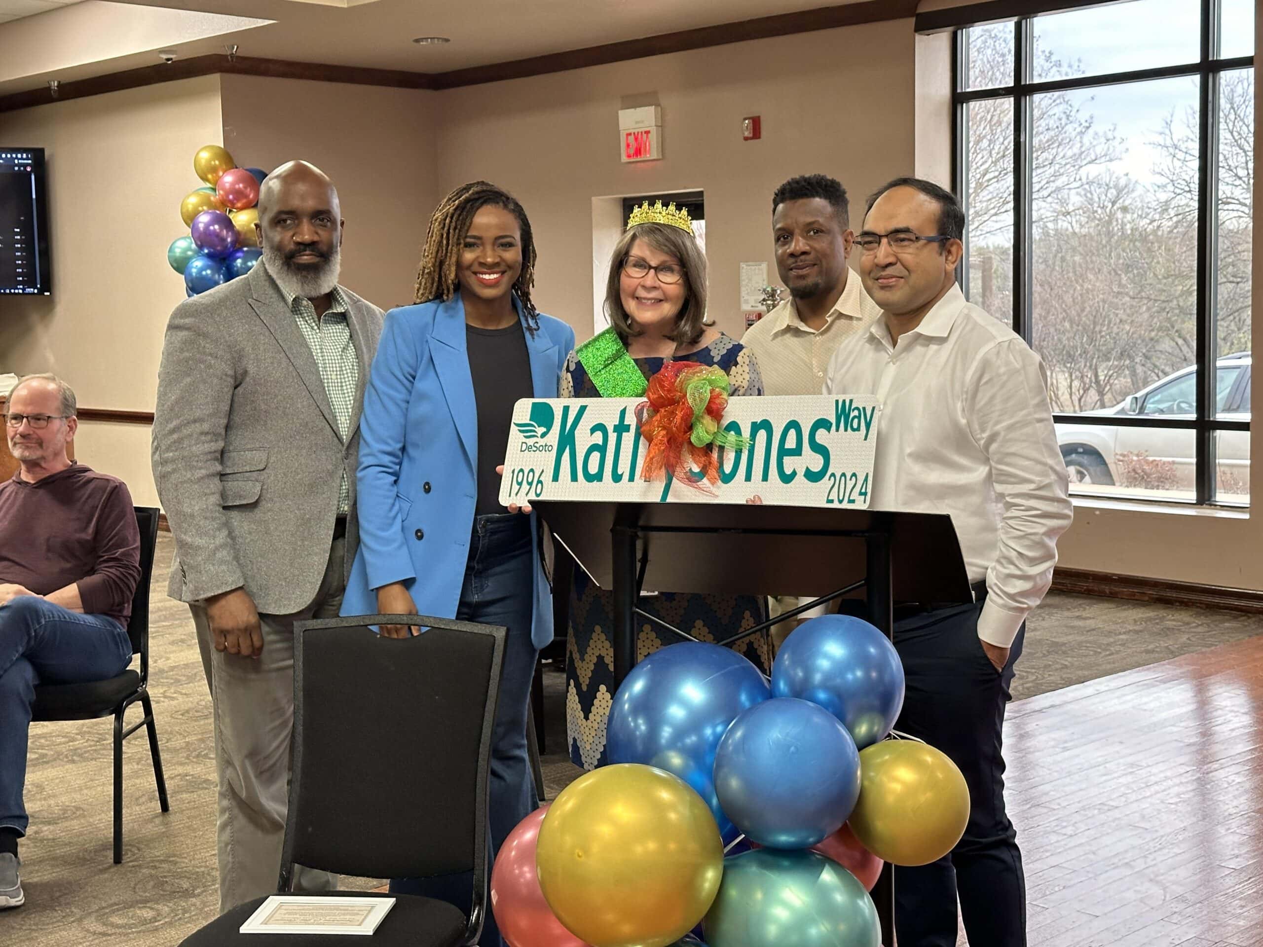 five people with street sign