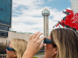 women wearning eclipse glasses