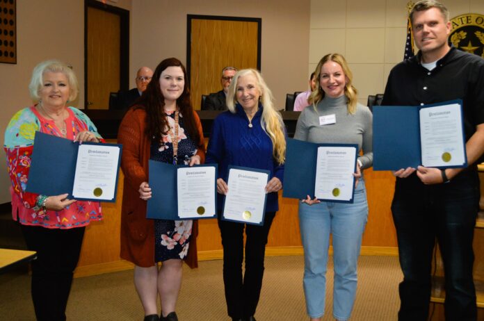 four ladies and a man holding proclamation