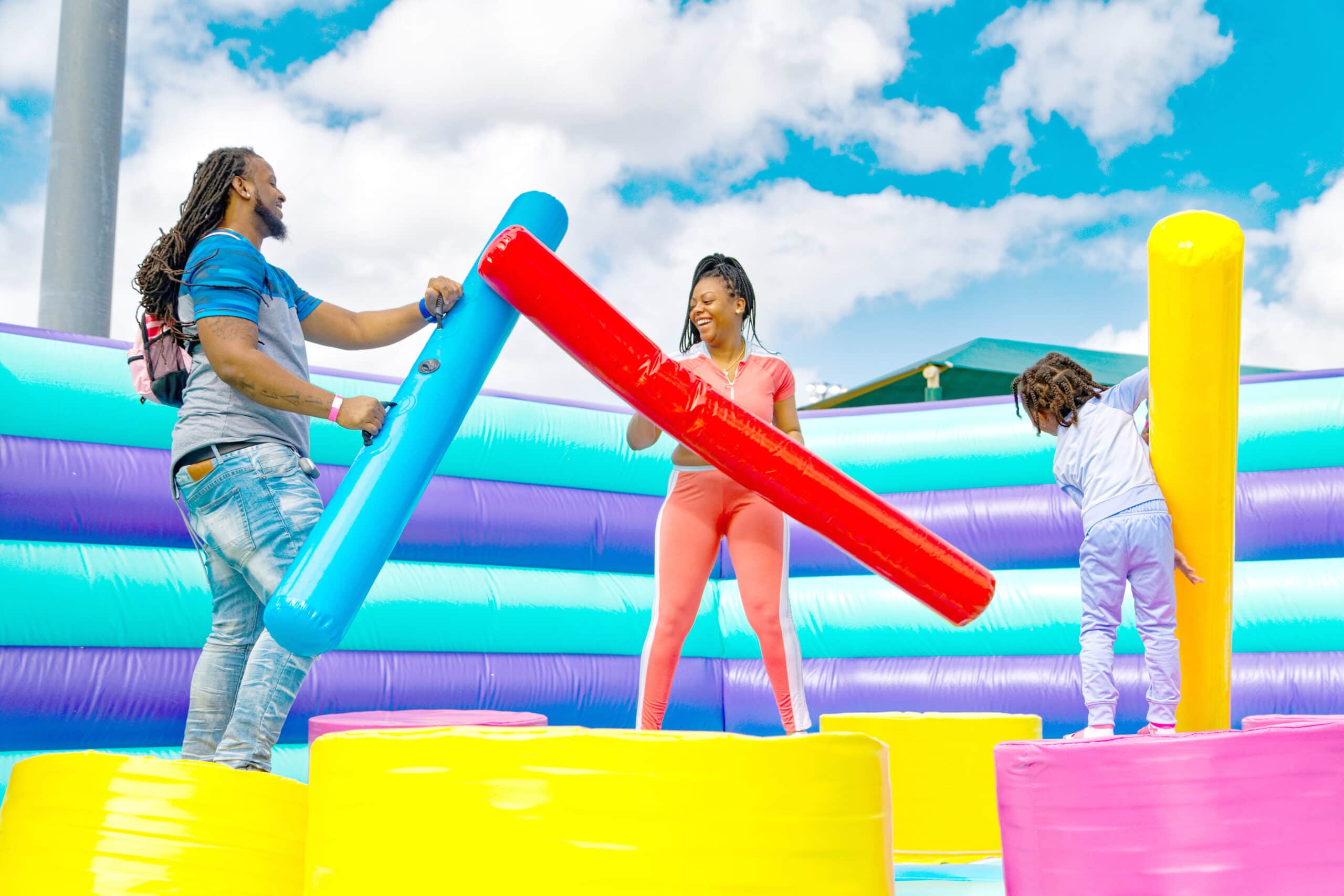 two people battling with inflatables