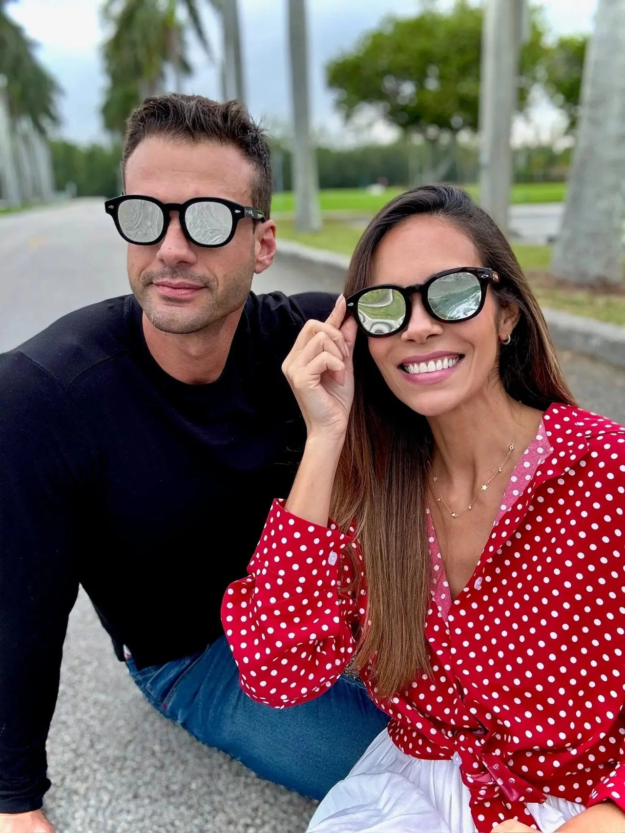 man and woman wearing eclipse glasses