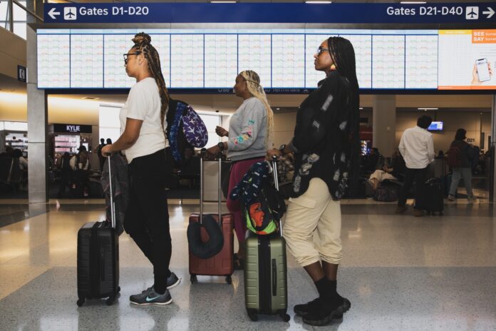 people standing in line with luggage