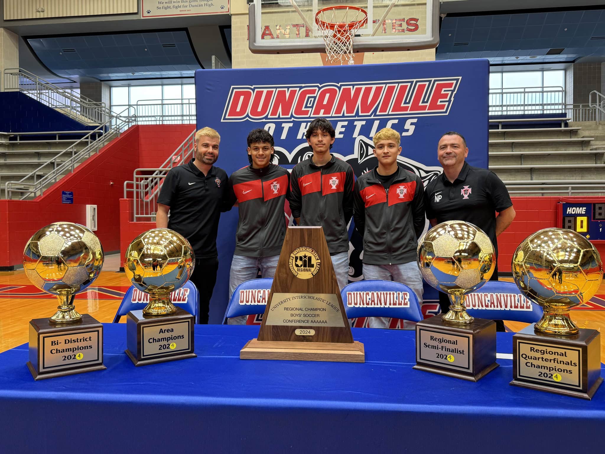 trophies with Duncanville soccer players