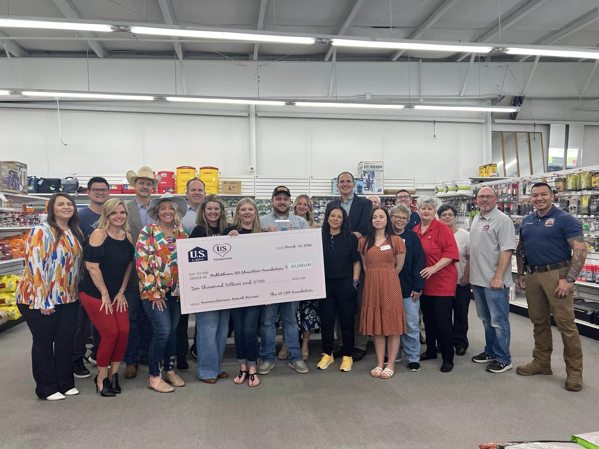 group of people with cardboard check in hardware store