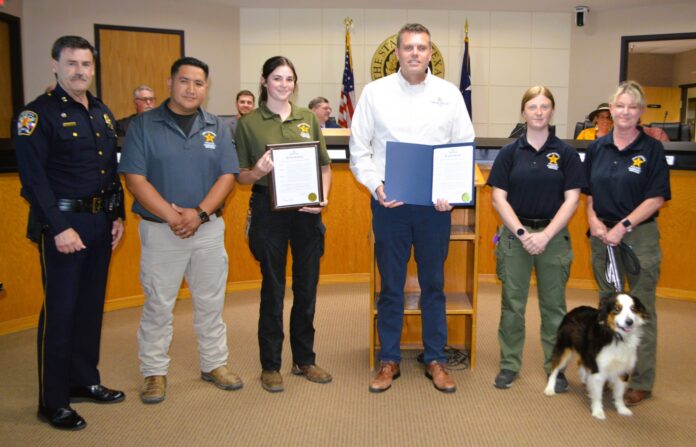 Pictured from left are Chief Carl Smith, Alex Cervantes, supervisor; and officers, Trinity Peel, Madison Reesing, and Karen Parrott. Also pictured is Mickey, a mini-Australian Shepherd