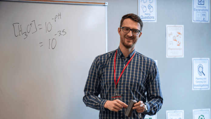 man standing in front of white board