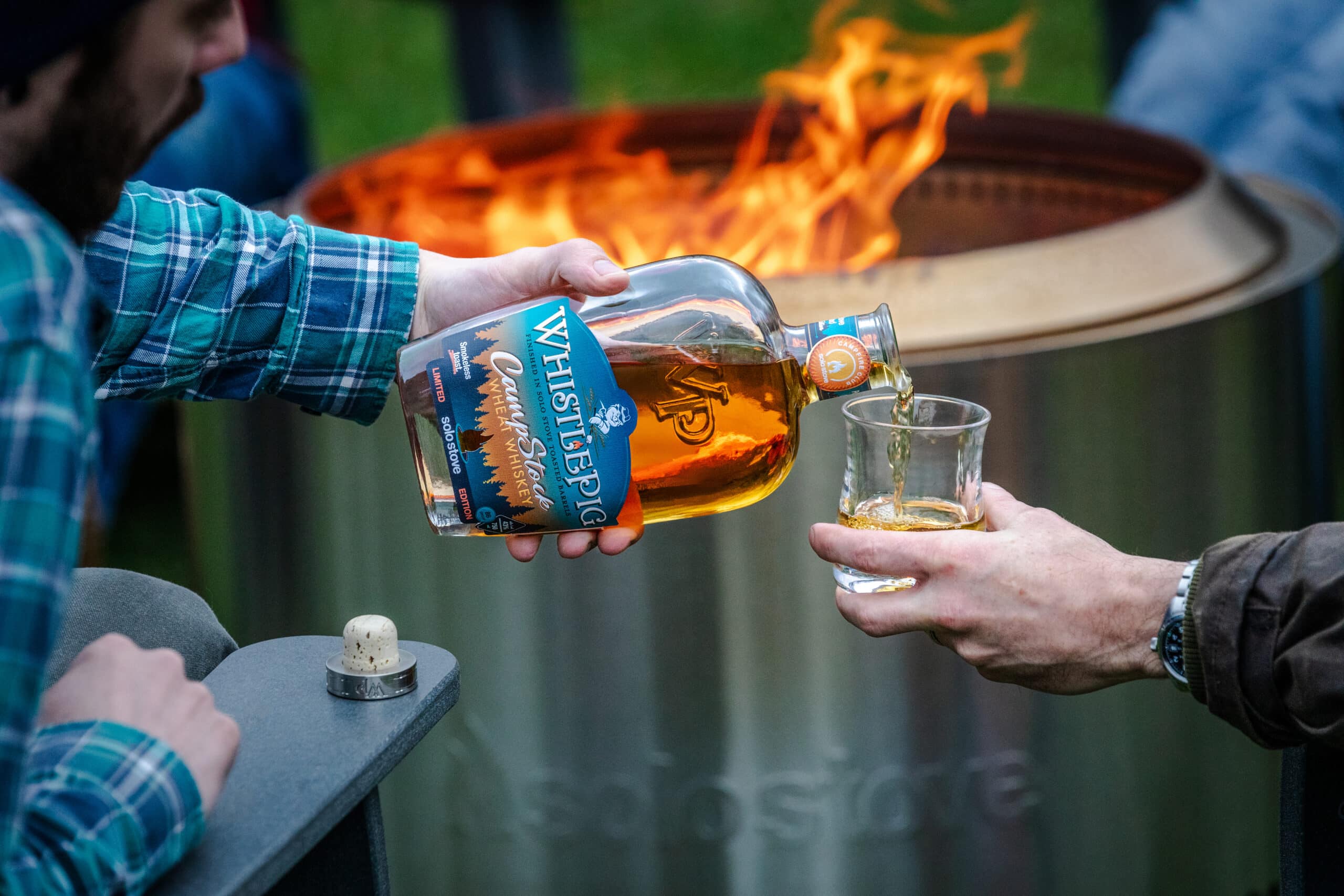 Whistle pig whiskey with fire in background