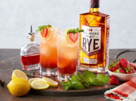 strawberry cocktails with bottle of rye whiskey