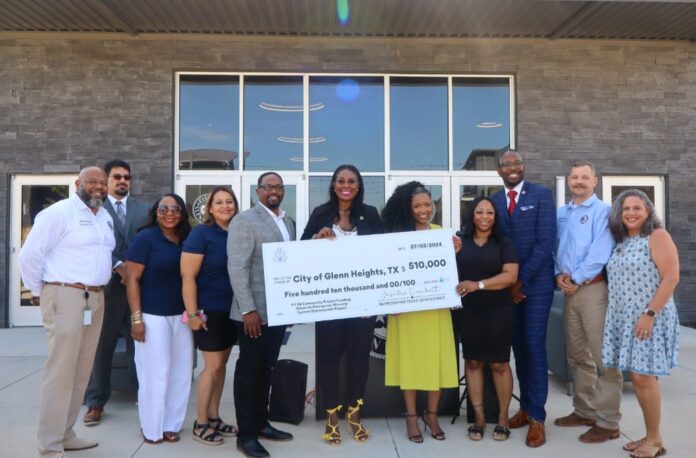 1000033888 group of people holding check
