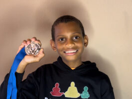 young man holding a medal