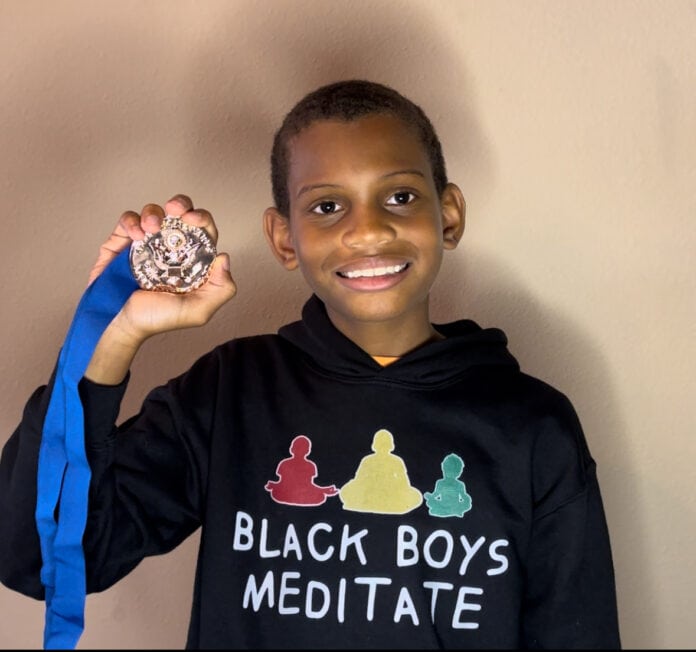 young man holding a medal