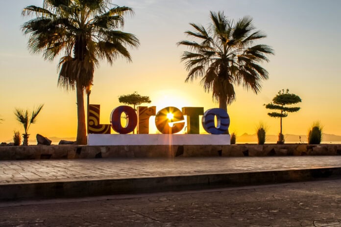 Loreto sign with sun setting