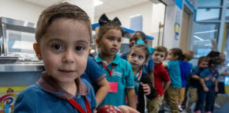 Harmony Public Schools – North Texas to Offer Free Breakfast and Lunch through Community Eligibility Provision student holding lunch tray