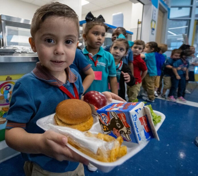 student holding lunch tray