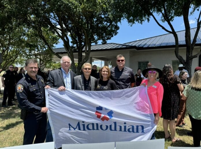 group of people holding Midlothian flag