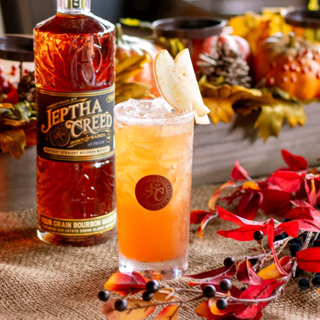 bourbon bottle with cocktail
