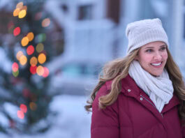 lady outside with Christmas lights in background