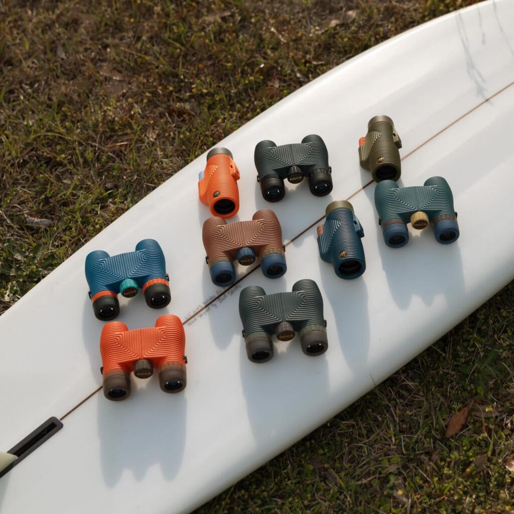 colorful binoculars on surfboard