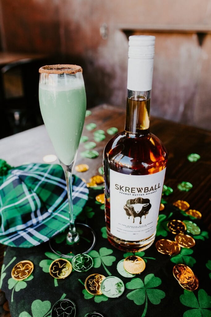 green cocktail with Skrewball bottle