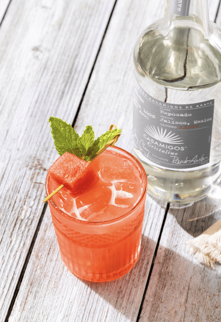 Pink drink with watermelon garnish